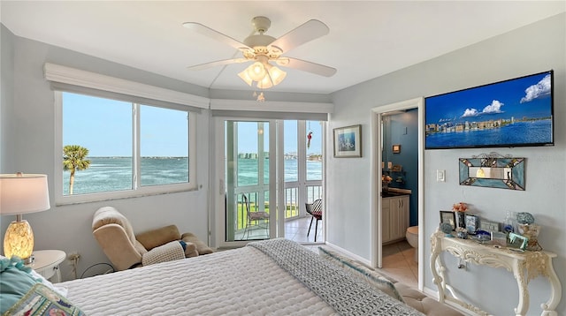 tiled bedroom with ceiling fan, access to outside, and ensuite bath