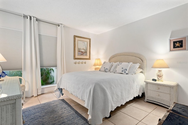 bedroom with a textured ceiling and light tile patterned flooring