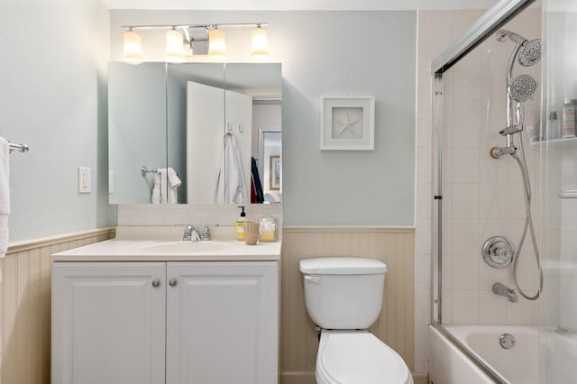 full bathroom featuring shower / bath combination with glass door, vanity, and toilet