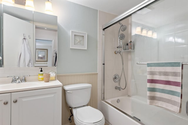 full bathroom with shower / bath combination with glass door, vanity, and toilet