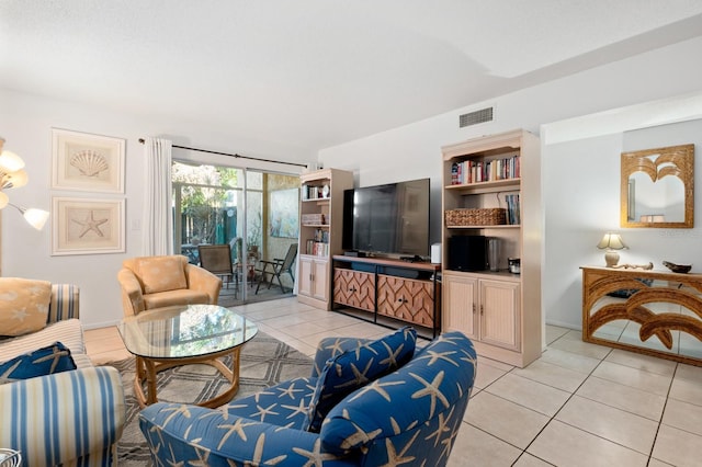 tiled living room featuring a wall of windows