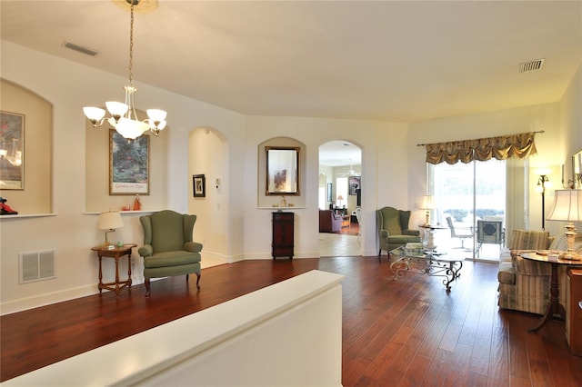 living room featuring dark hardwood / wood-style floors and a notable chandelier