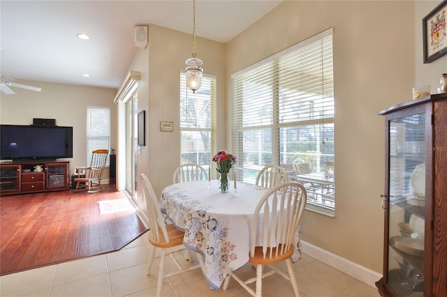 tiled dining area with ceiling fan