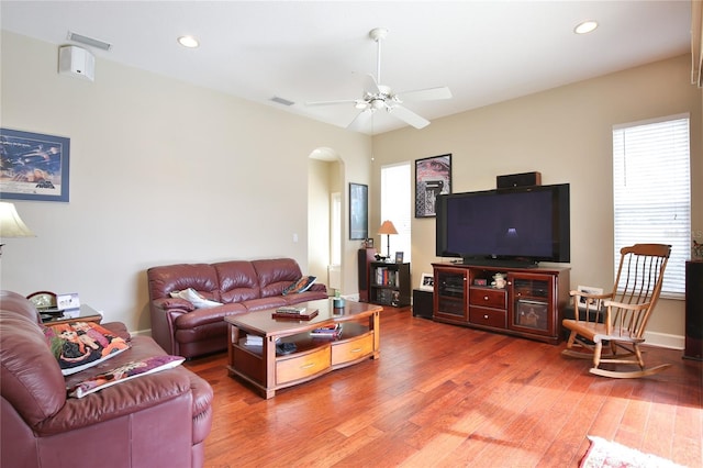 living room with hardwood / wood-style flooring and ceiling fan