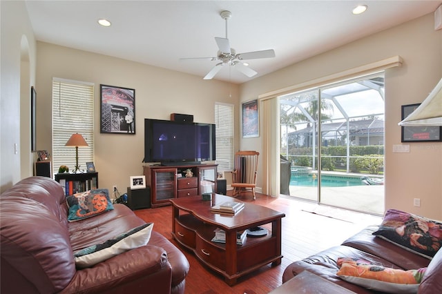 living room featuring wood-type flooring and ceiling fan