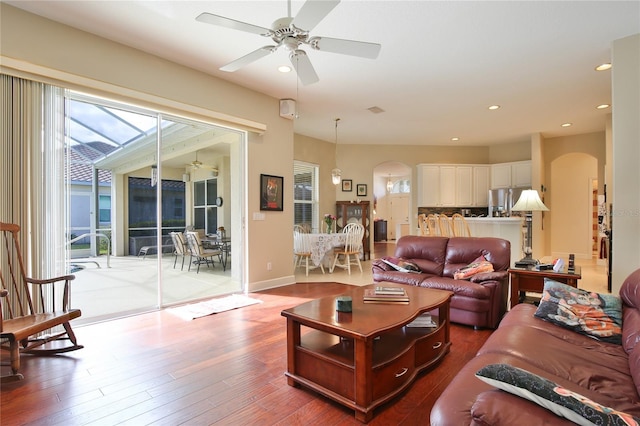 living room featuring wood-type flooring and ceiling fan