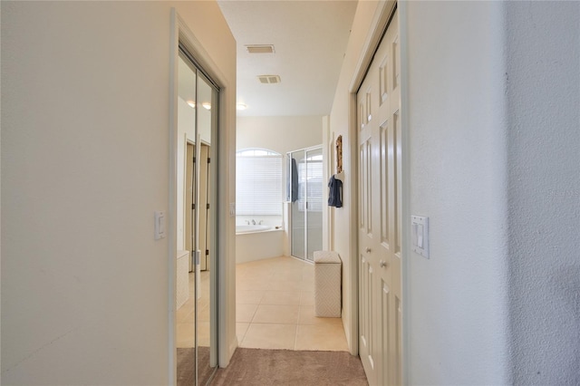 hall with light tile patterned flooring