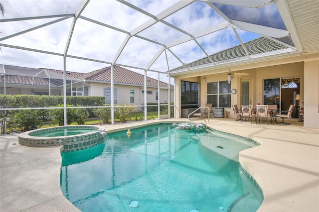 view of swimming pool featuring a patio area, an in ground hot tub, ceiling fan, and glass enclosure