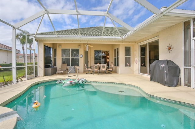 view of swimming pool with area for grilling, a lanai, a patio area, and ceiling fan