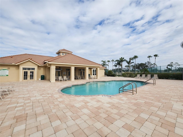 view of pool featuring a patio and french doors