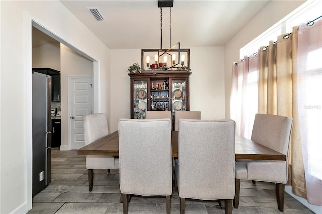 dining room featuring hardwood / wood-style floors and a chandelier