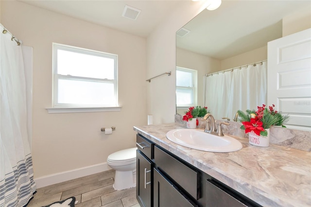 bathroom featuring hardwood / wood-style flooring, vanity, and toilet