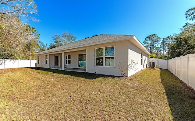 back of property featuring a patio area, central AC, and a lawn