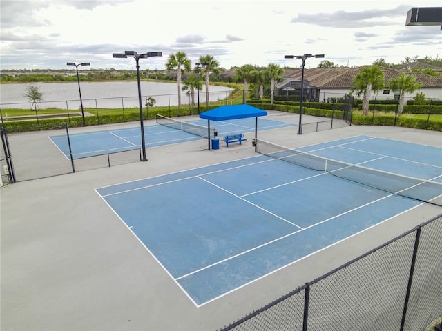 view of sport court featuring basketball court and a water view