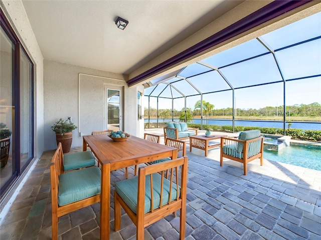 view of patio featuring a water view, a swimming pool with hot tub, an outdoor living space, and a lanai