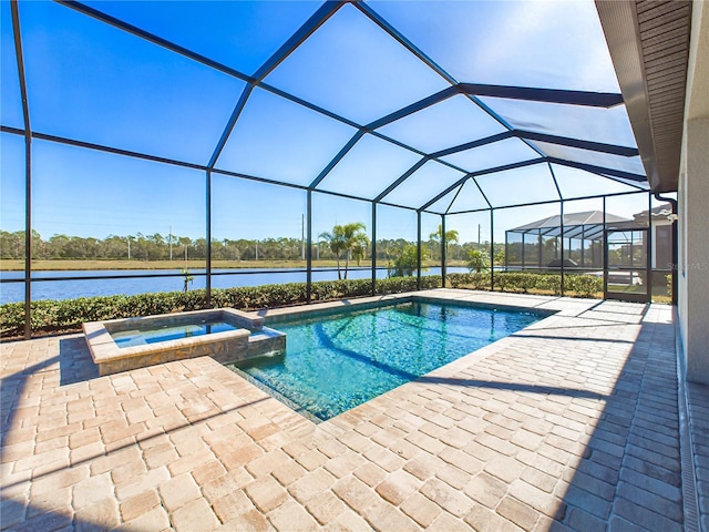 view of swimming pool featuring an in ground hot tub, glass enclosure, a water view, and a patio