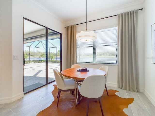 tiled dining area featuring crown molding