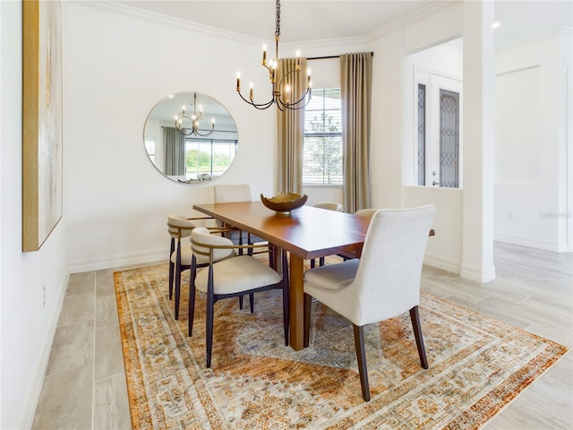 dining space featuring ornamental molding and a notable chandelier