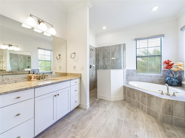 bathroom with a wealth of natural light, vanity, crown molding, and shower with separate bathtub