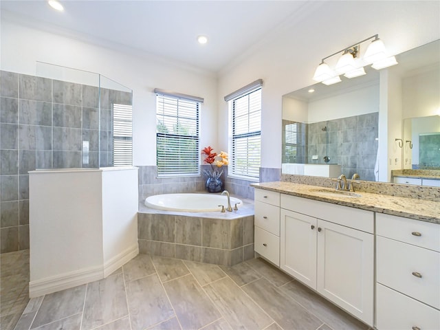 bathroom featuring ornamental molding, separate shower and tub, and vanity