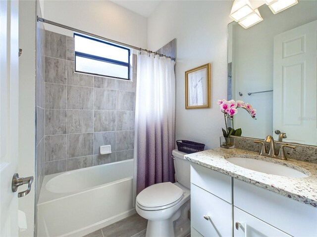 full bathroom featuring shower / bath combo, vanity, and toilet