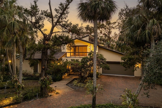 view of front of home featuring a garage and a balcony