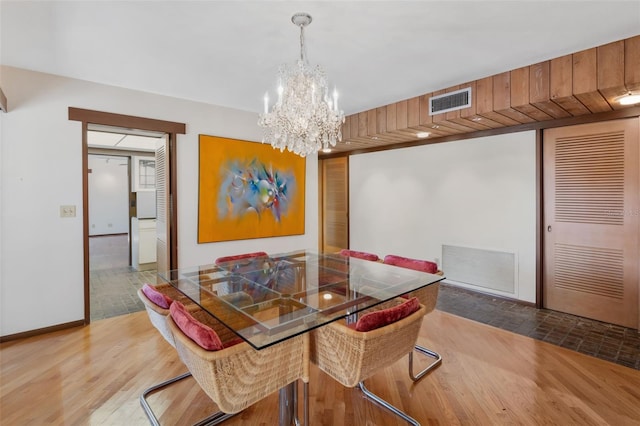 dining room featuring hardwood / wood-style flooring and an inviting chandelier