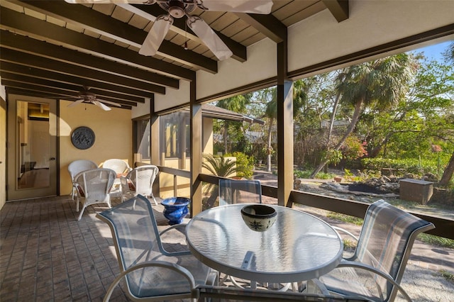 sunroom / solarium with beamed ceiling and ceiling fan