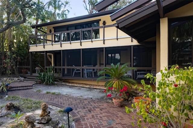 rear view of property featuring a balcony