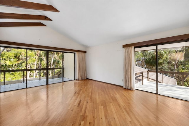 interior space with lofted ceiling with beams and light hardwood / wood-style floors