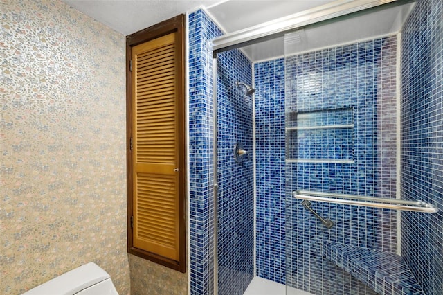 bathroom with an enclosed shower and toilet