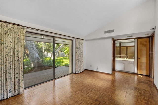 unfurnished room with parquet flooring and lofted ceiling