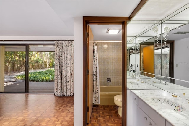 full bathroom with parquet floors, vanity, shower / bath combo, and toilet