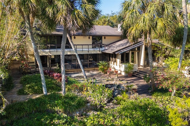 rear view of house featuring a balcony