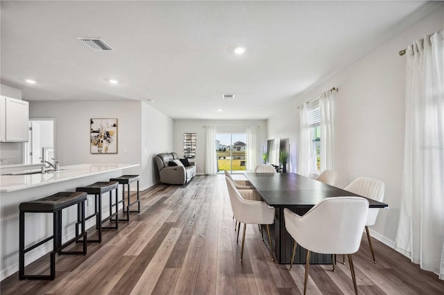 dining space featuring dark hardwood / wood-style flooring and sink