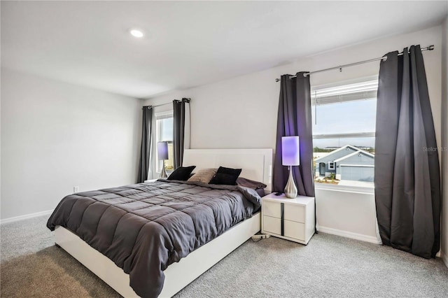 carpeted bedroom featuring multiple windows