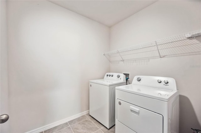 laundry area featuring light tile patterned flooring and washer and clothes dryer