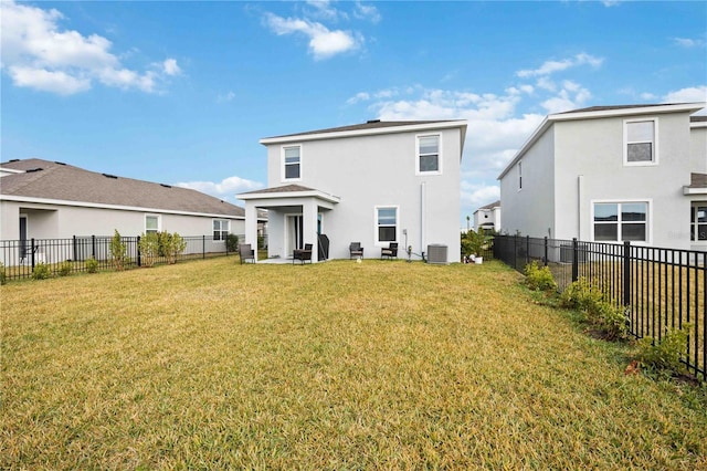 back of property with a yard and central AC unit