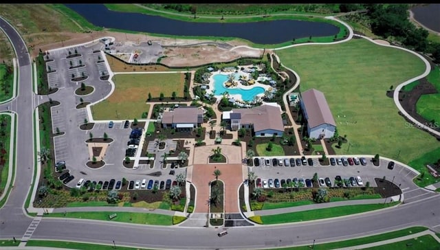 birds eye view of property with a water view