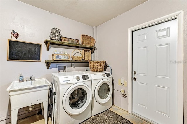 laundry area with sink and washing machine and clothes dryer