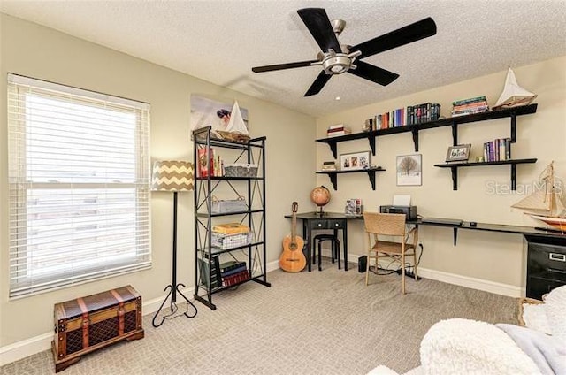 carpeted home office with ceiling fan, beverage cooler, and a textured ceiling