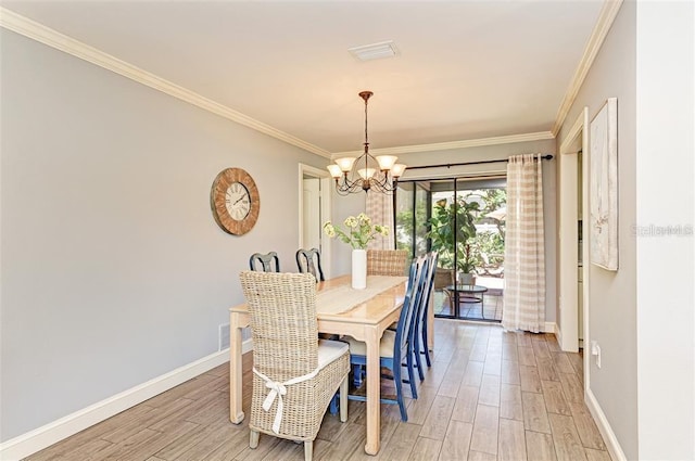 dining area featuring wood-type flooring, ornamental molding, and a chandelier