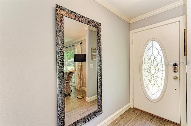 entryway with hardwood / wood-style floors and crown molding