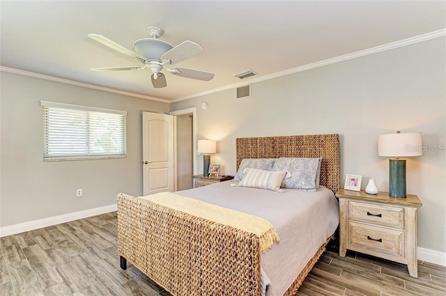 bedroom featuring hardwood / wood-style flooring, ceiling fan, and ornamental molding