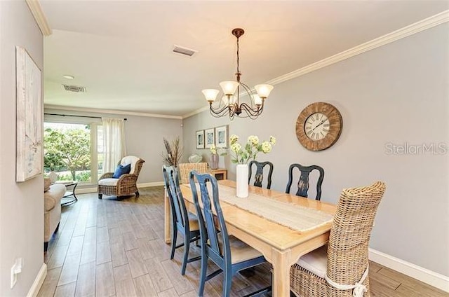 dining room with wood-type flooring and crown molding