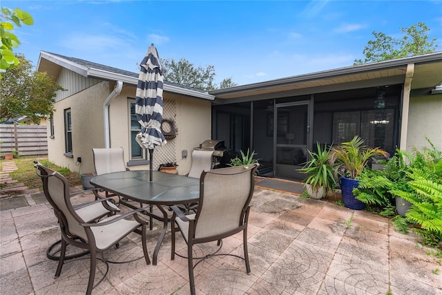 view of patio / terrace featuring a sunroom