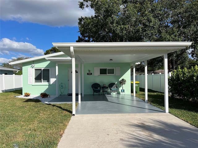 view of front of property with a front yard and a carport