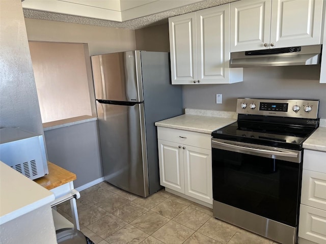 kitchen with stainless steel appliances, light tile patterned floors, and white cabinets