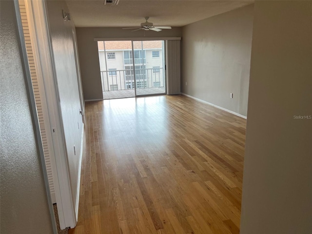 unfurnished room with ceiling fan and light wood-type flooring