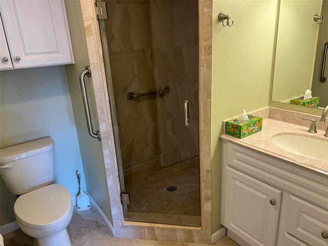 bathroom featuring vanity, a shower with shower door, and toilet